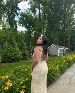 Detail of yellow floral lace embroidery on a backless V-neck slim fit midi dress