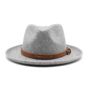 Close-up of light gray fedora hat featuring a brown faux leather belt with metal studs