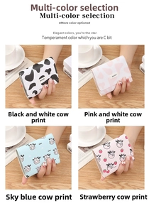 Detail of compact tri-fold cow print purses with secure snap buttons and PU leather finish