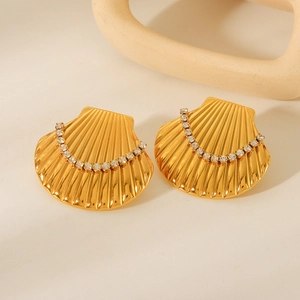 Macro detail of 18k gold plated scallop stud earrings with sparkling zircon accents