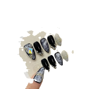 Dark marble almond press-on nails with luxury rhinestones and large colorful gemstones