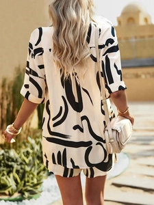 Rear view of a loose-fit white summer shirt with abstract black artistic print and clean cut