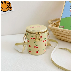 Detail of yellow PU bucket bag with cherry prints and embroidered cherry text for girls