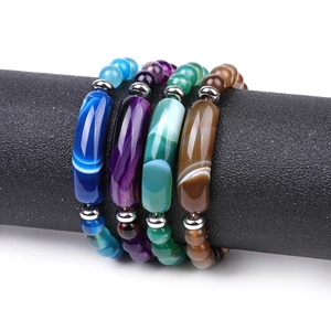 Macro shot of 8mm natural stone beaded bracelets in blue, green, and brown on display