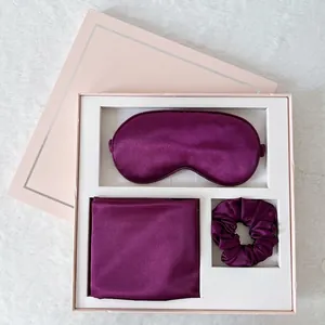Detailed view of dark purple satin sleep set with eye mask and scrunchie in gift box
