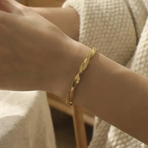 Elegant gold twisted snake bone cuff bracelet with matte textured finish for women