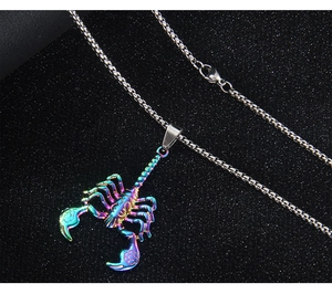Detail of a rainbow-colored scorpion pendant with a silver box chain on dark background