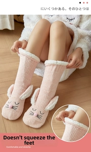 Close-up of pink rabbit fleece socks with plush 3D ears and cozy lamb wool lining