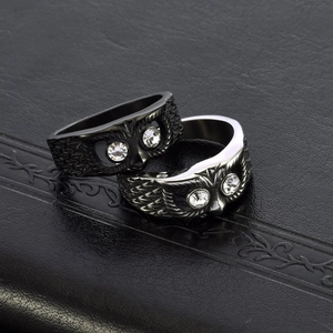 Vintage owl rings in black and silver finishes featuring crystal eyes on leather book