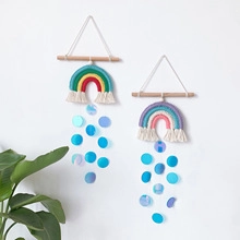 Detail of woven boho rainbow wall hanging with cotton rope tassels and blue sequins