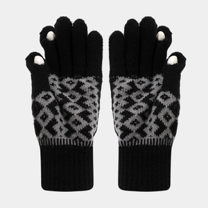 Close-up of winter knit gloves with gray geometric patterns and touchscreen finger openings