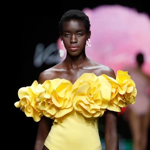 Detail of 3D yellow floral appliqué on a strapless swimsuit with textured fabric