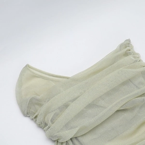 Detailed macro shot of shimmering champagne mesh fabric with ruched neckline textures