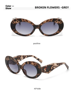 Macro view of oval cat-eye sunglasses with thick tortoise frames and triangle temple detail