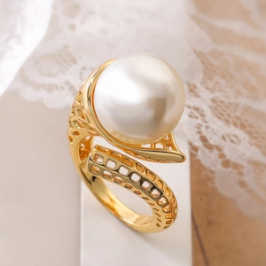 18K gold plated hollow grid ring with a large white pearl on white lace background
