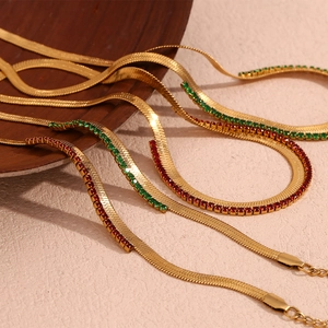 Detail of 18K gold plated herringbone chain with red and green zircon inlay
