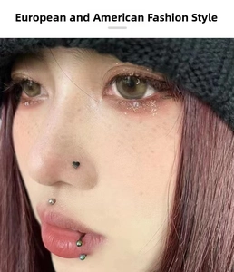 Close-up of stainless steel heart nose stud and horseshoe septum ring on a model