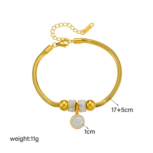Gold stainless steel bracelet with sparkling rhinestone disc pendant and beaded accents