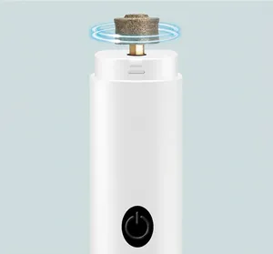 Detail view of electric pet nail grinder with white matte finish and central power button