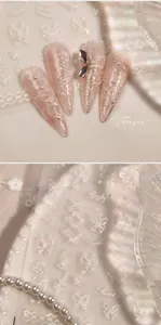 Macro shot of 3D bow nail stickers with laser butterfly patterns and pearls