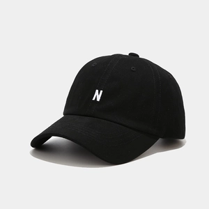 Close-up of high-quality white N letter embroidery on a black cotton twill baseball cap