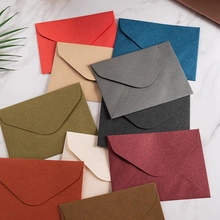 Flat lay of colorful vintage kraft paper envelopes in red blue and green tones