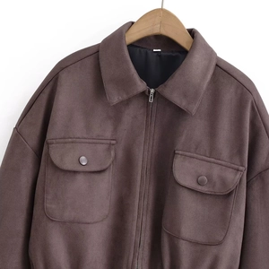 Close-up of brown suede jacket showing lapel collar, metal zipper and pocket detail