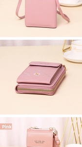 Detail view of pink vertical crossbody phone bag with embroidered flower and zipper