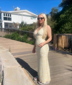 Close-up of fine hollow lace pattern and slim fit fisheye cut on a long summer dress