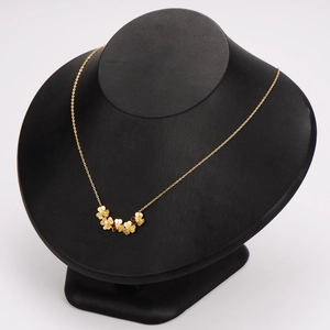 Elegant 18K gold plated clover flower necklace with crystals on black display stand