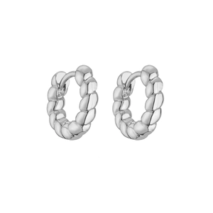 Detailed macro view of silver twisted rope hoop earrings with high-polish metallic finish