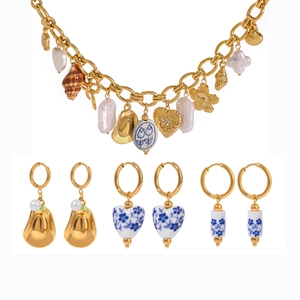 Golden multi-element jewelry set with stainless steel pearl charms and ceramic earrings