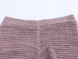 Detail view of mauve knit top waist showing ribbed texture and open knit pattern