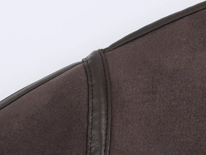 Detailed view of dark brown knitted jacket with leather trim and precision stitching