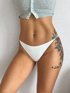 Detail of white cotton sports briefs with thin side straps worn by a fitness model