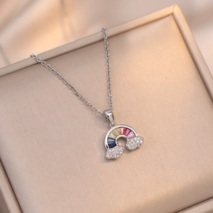 Macro detail of rainbow zircon pendant with pavé clouds on a silver-tone chain