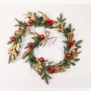 Close-up of artificial Christmas garland with red ornaments, gold leaves, and pine cones