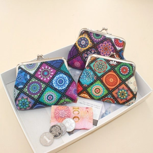 Macro view of retro mandala pattern coin purses with metal clasps and coins for scale