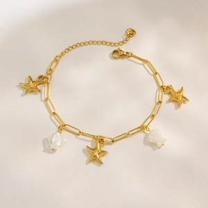 Golden stainless steel ocean bracelet with starfish and white shell charms on a chunky chain