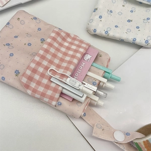 Detailed view of pink floral and plaid canvas nurse pocket protector with snap handle