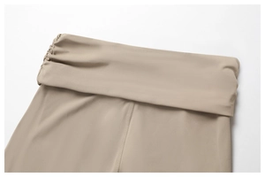Close-up of high-waist yoga pants with fold-over waistband and side ruching details