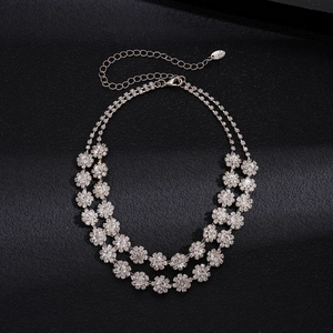 Detail of double-layer silver necklace with rhinestone floral cluster and lobster clasp