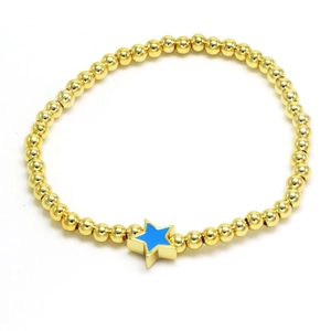 Close-up of golden beaded bracelet featuring a blue enamel star-shaped pendant detail