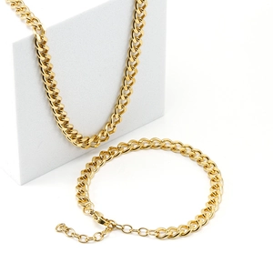 Golden 18K stainless steel Cuban link necklace and bracelet set on white background