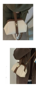 Detail of retro cream and brown contrast handbag with a golden rotating metal clasp