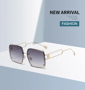 Detail showing the square metal frame sunglasses with gradient lenses and hollow geometric temples