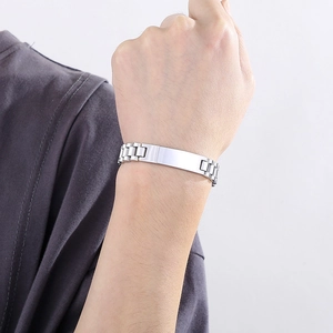 Polished stainless steel ID bracelet with engravable blank bar shown on a male wrist