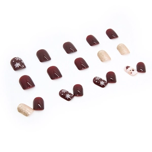 Faux ongles de Noël bordeaux et paillettes dorées avec flocons de neige et motif Père Noël