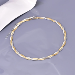 Detail of two-tone twisted snake chain necklace with lobster clasp and extension link