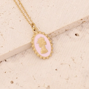 Detailed close-up of a vintage golden medallion necklace with pink cameo on stone background